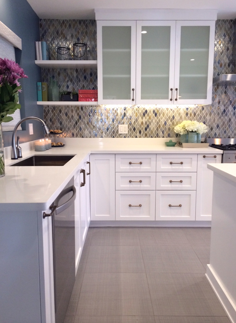 HGTV kitchen remodel view of the backsplash tile, glass upper cabinets, and sink area